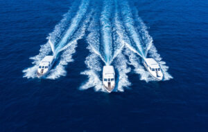 A high-speed luxury speedboat cutting across clear Maldivian water, representing Maldives Speed boat Transfers and unmatched reliability.