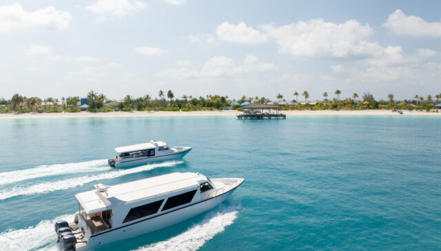 Private speed boat transfers approaching a beautiful Maldives island.